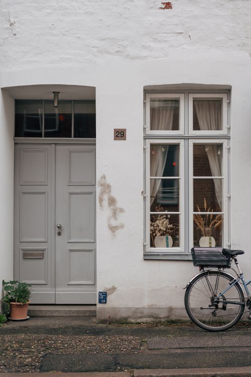 Free A picturesque view of a Lübeck street facade featuring a door, window, and bicycle. Stock Photo