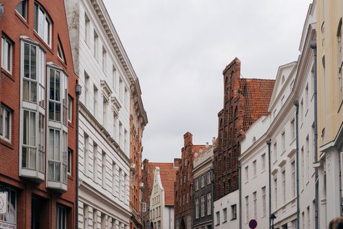 Free Explore the historic architecture and cobbled streets of Lübeck, Germany, showcasing iconic brick facades. Stock Photo
