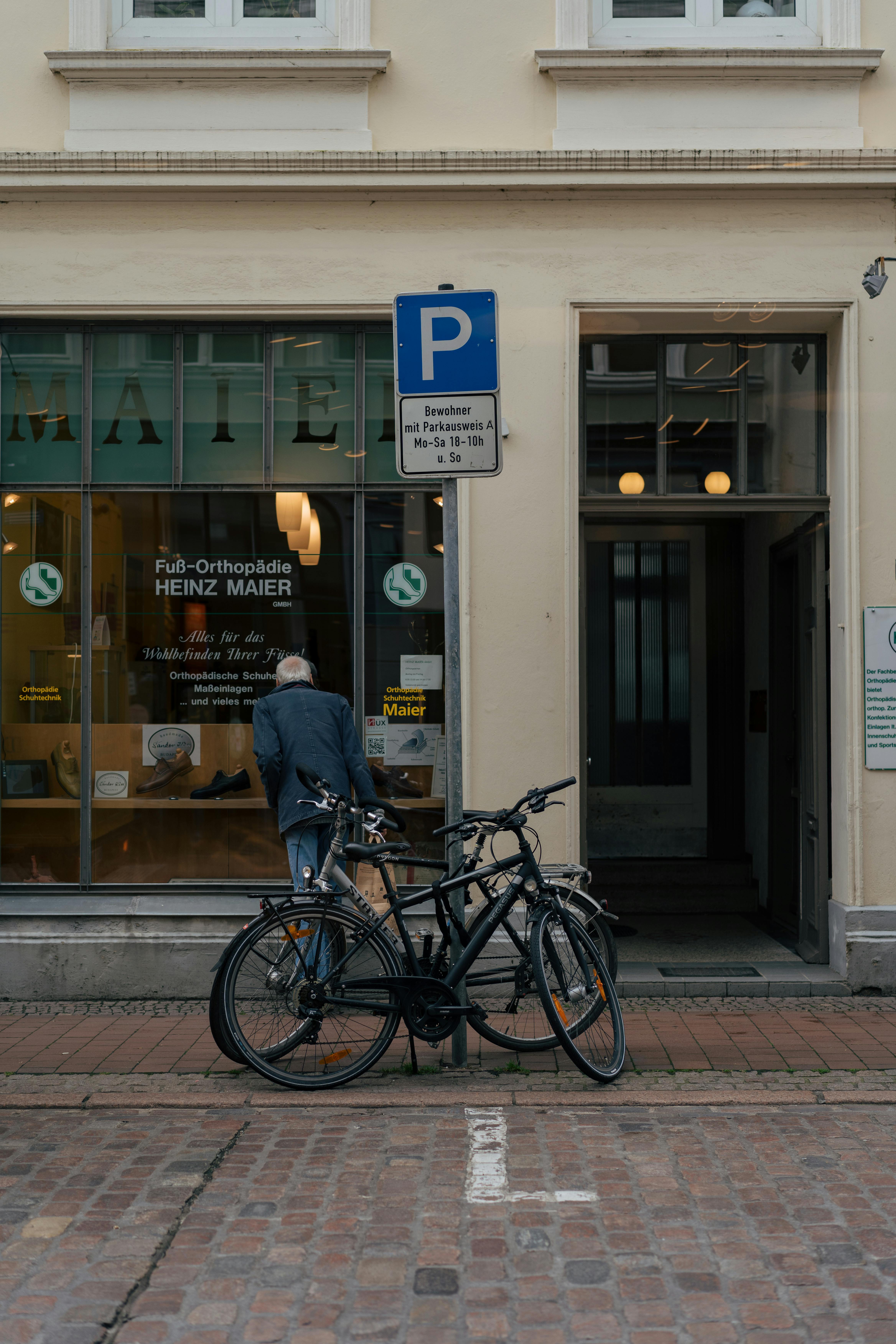 Bicycles in front of Heinz Maier orthopedic shop in Lübeck, Germany. Urban European street scene.