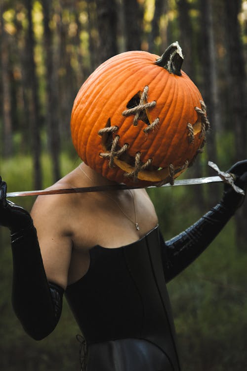 Portrait of Woman with Pumpkin Head and Sword