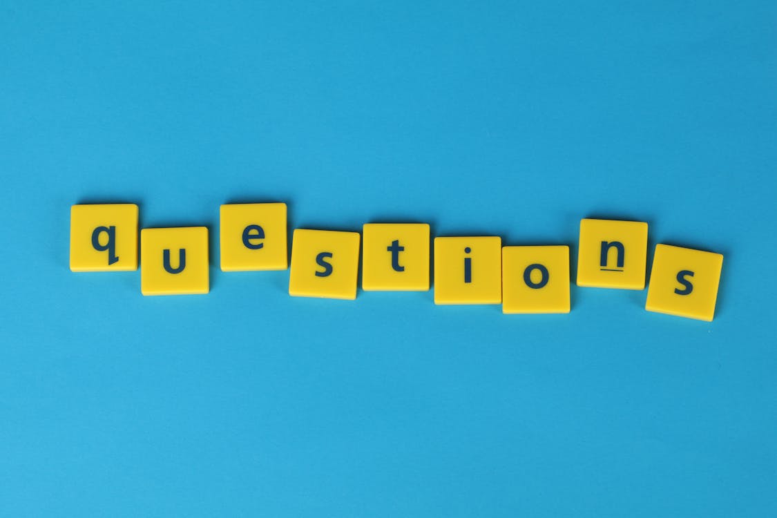 The word "questions" in yellow tiles with a blue background.