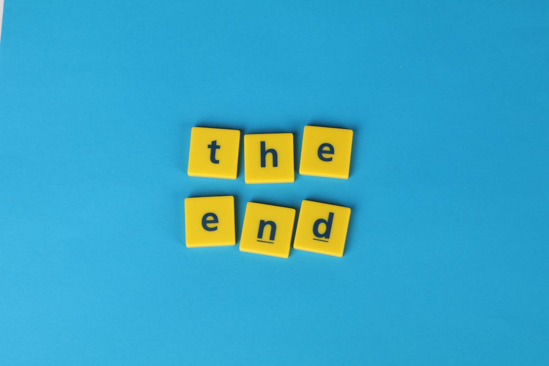 Free Letters On Yellow Tiles Forming "The End" Text Stock Photo