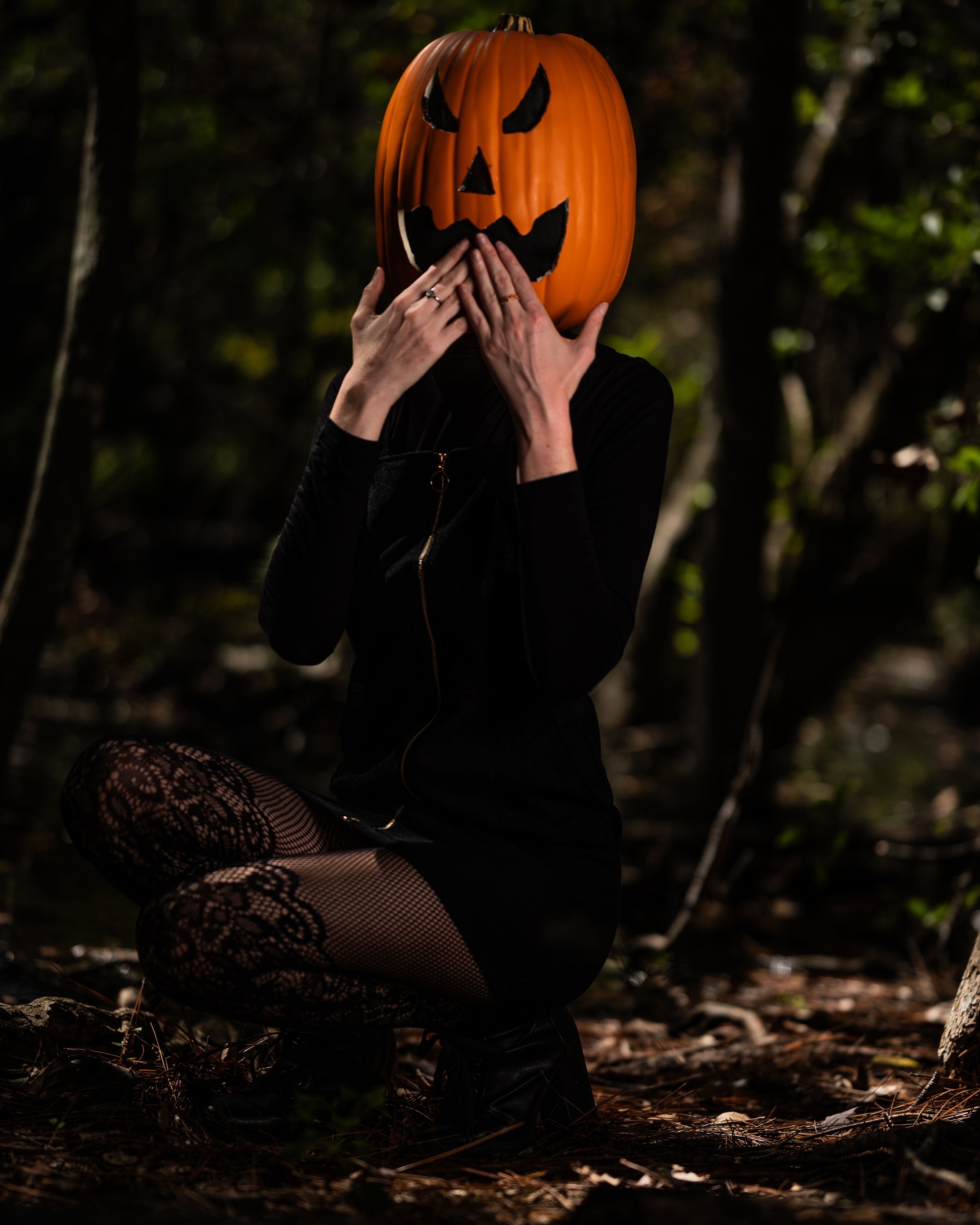 Woman in Black Dress with Pumpkin on Head Posing in Forest · Free Stock  Photo
