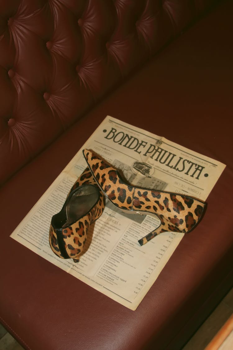 Pair Of Leopard Print Shoes Lying On A Restaurant Menu