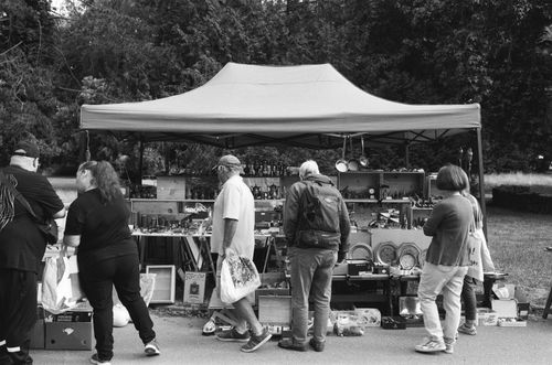 Free A vibrant flea market in Nancy, showcasing buyers browsing stalls in monochrome. Stock Photo