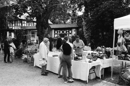 Bustling street market scene in Nancy, France with people exploring stalls.