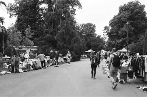 Free Black and white scene of a bustling outdoor market in Nancy, France, with people and stalls lining the street. Stock Photo