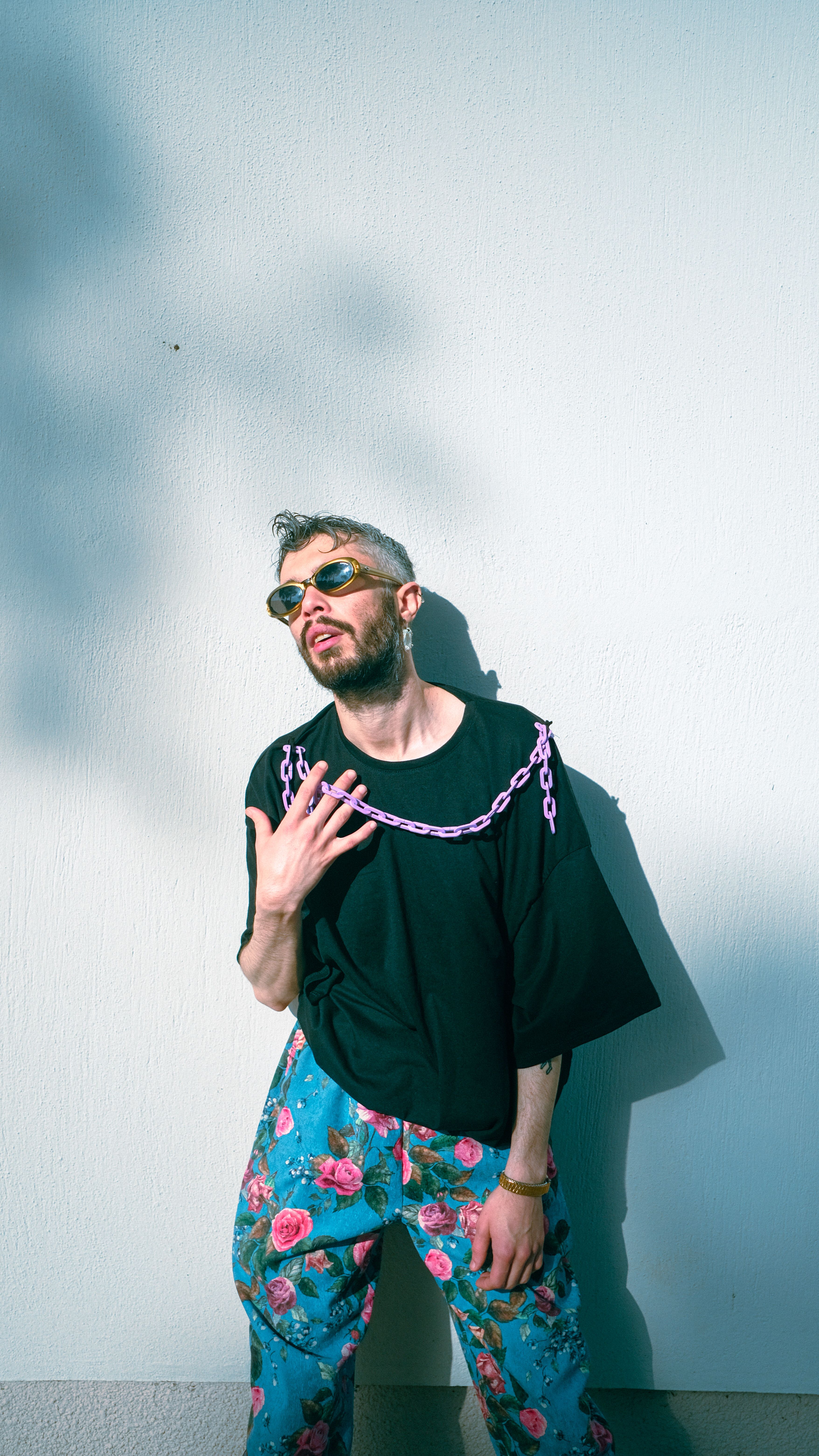 Man Wearing Sunglasses Posing in Front of a White Wall · Free Stock Photo