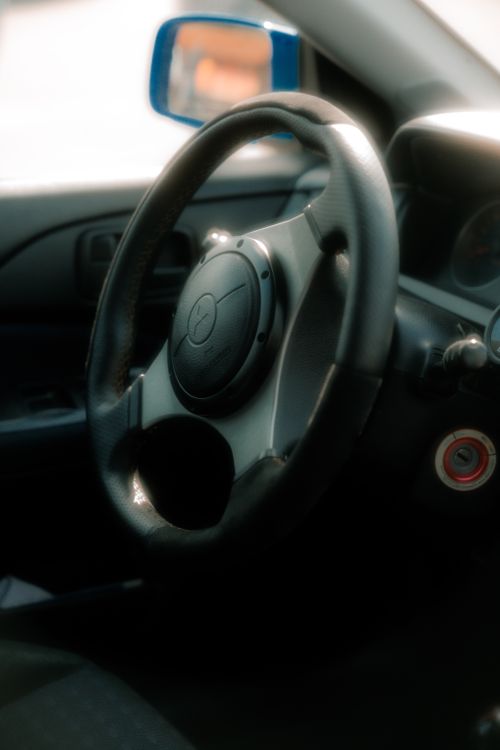 Free Artistic shot of a car steering wheel with soft lighting, taken in Pavia, Italy. Stock Photo
