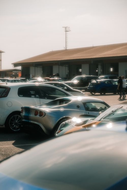 Free A collection of sports cars parked in an urban lot in Pavia, Italy, with a warm light ambiance. Stock Photo
