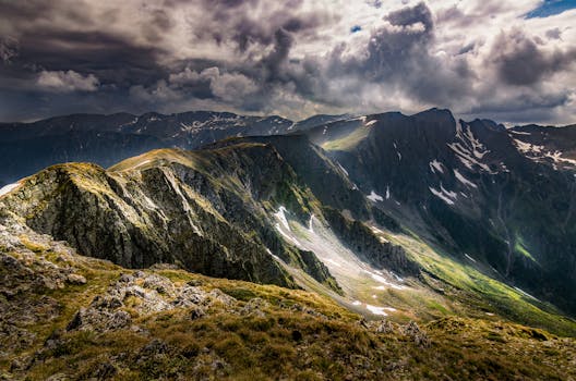 Stunning panorama of the Fagaras Mountains with dramatic clouds in Romania.