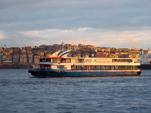 Free A passenger ferry sailing through the Bosphorus Strait with Istanbul's vibrant skyline in the background. Stock Photo