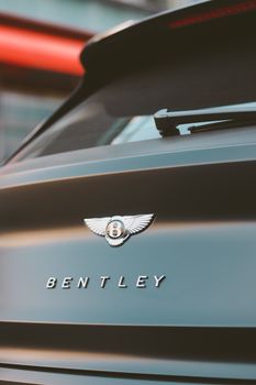 Close-up of a Bentley car logo, capturing luxury and elegance in Dubai.