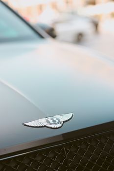 Close-up of the iconic Bentley emblem on a luxury car, symbolizing opulence and prestige.