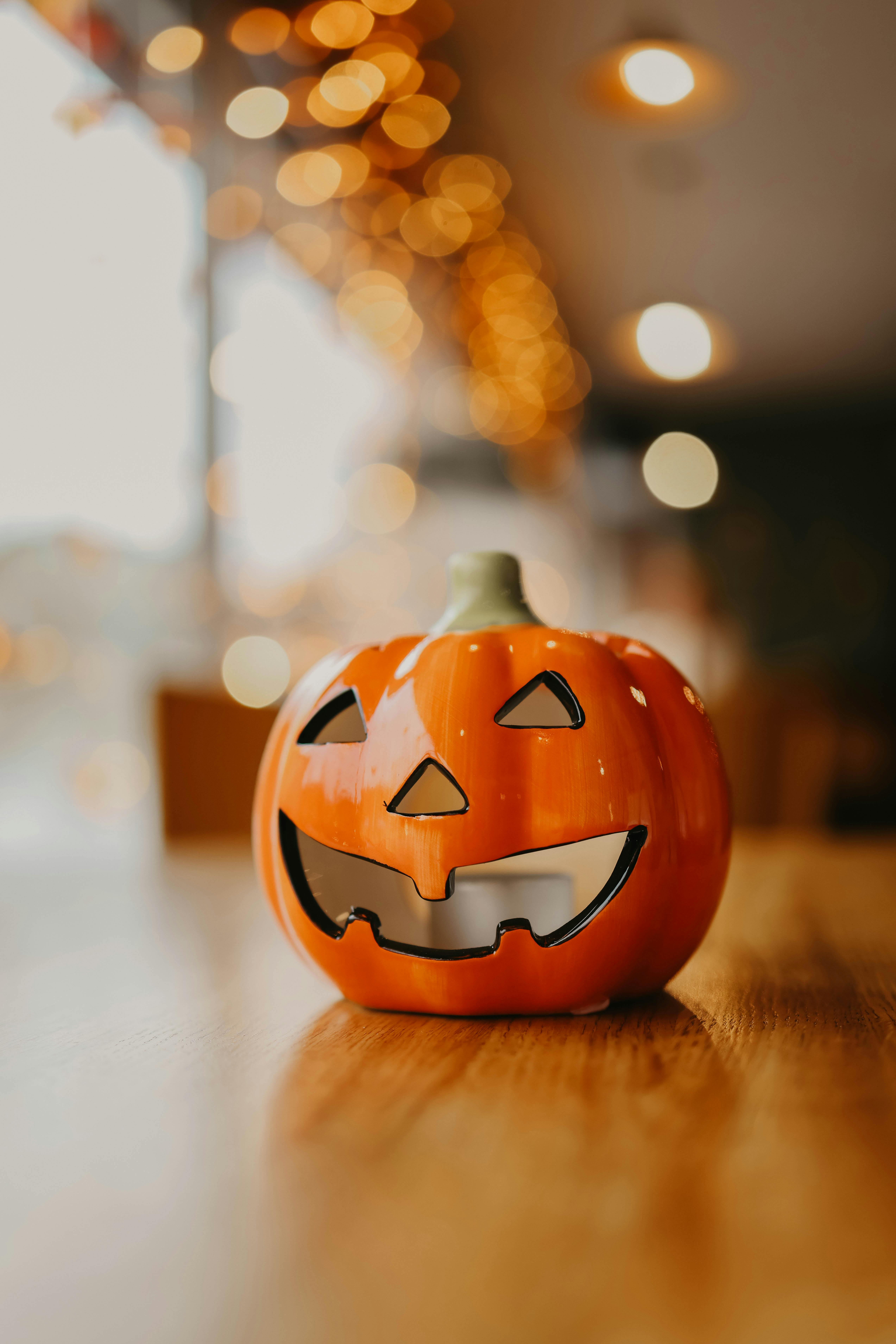 orange ceramic halloween pumpkin lying on a wooden table