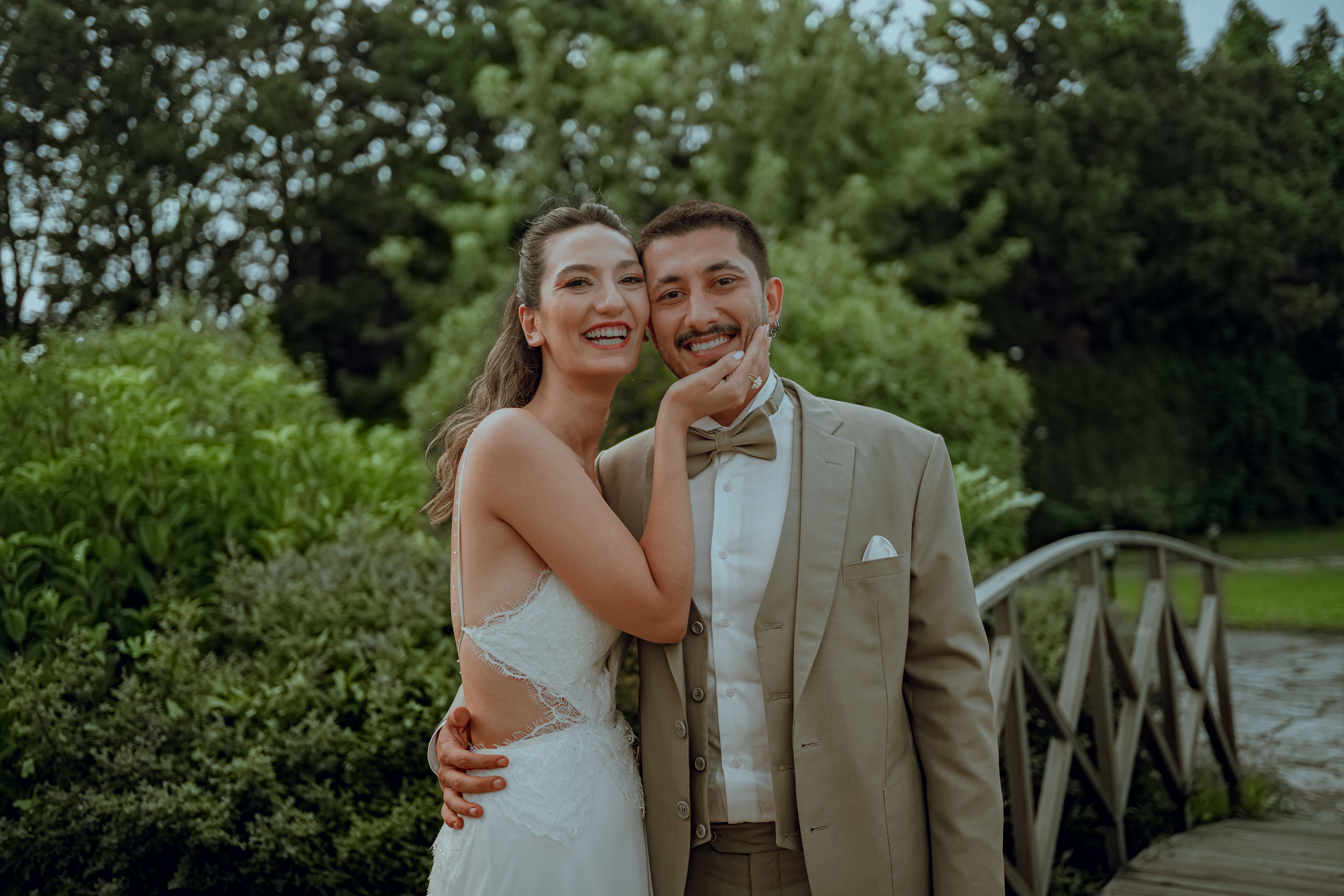 Happy couple embracing in a vibrant garden during their wedding day.