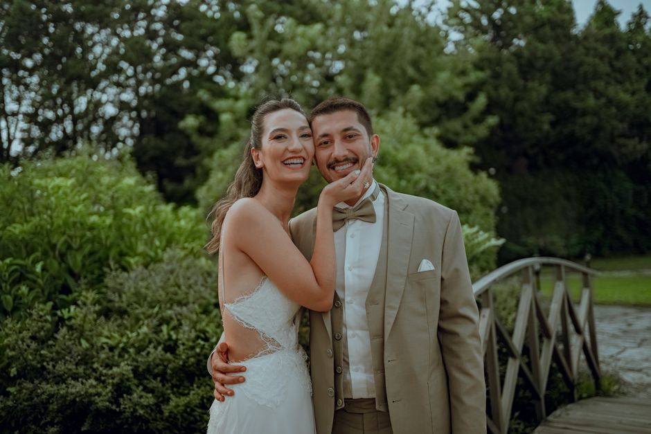 Happy couple embracing in a vibrant garden during their wedding day.