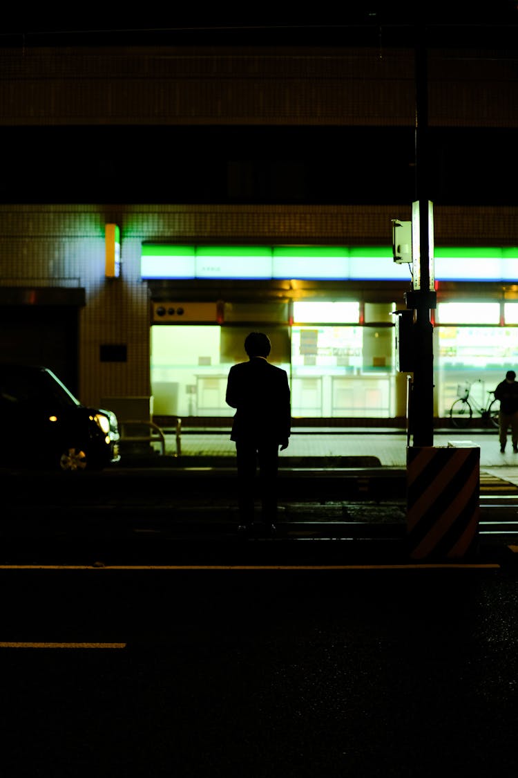 Silhouette Of Man In City At Night