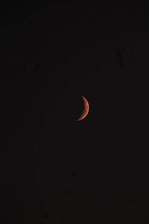 Free A tranquil crescent moon set against a deep black night sky, offering ample copy space. Stock Photo