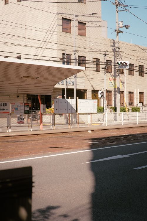 Free An urban bus station with sunlight casting shadows, capturing the essence of city life. Stock Photo