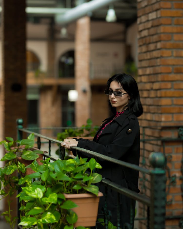 Woman Posing On A Balcony With Plants 