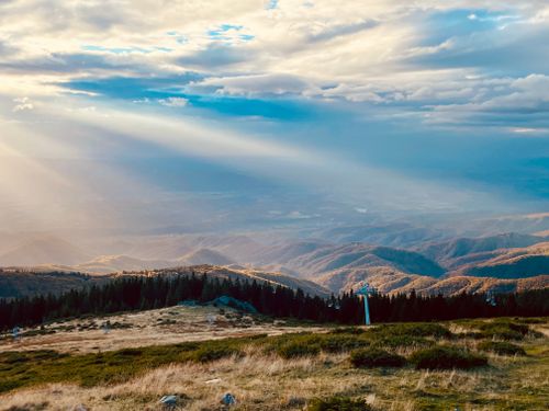 Free Captivating autumn view of sunrays illuminating Carpathian Mountains in Romania. Stock Photo