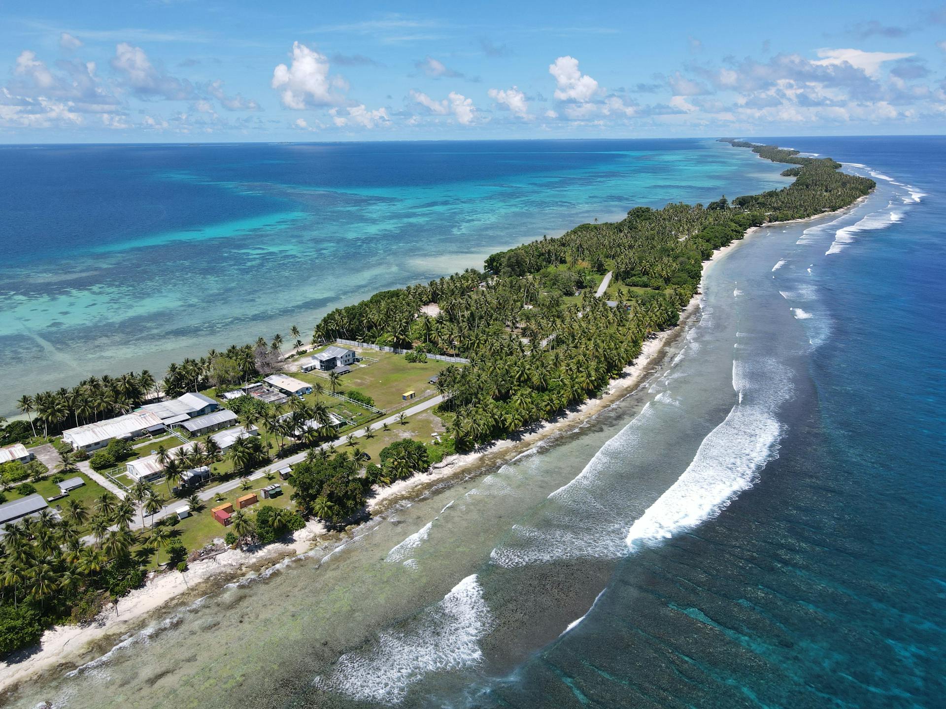 Aerial view of the tropical coastline and crystal-clear ocean at Majuro Atoll, Marshall Islands.