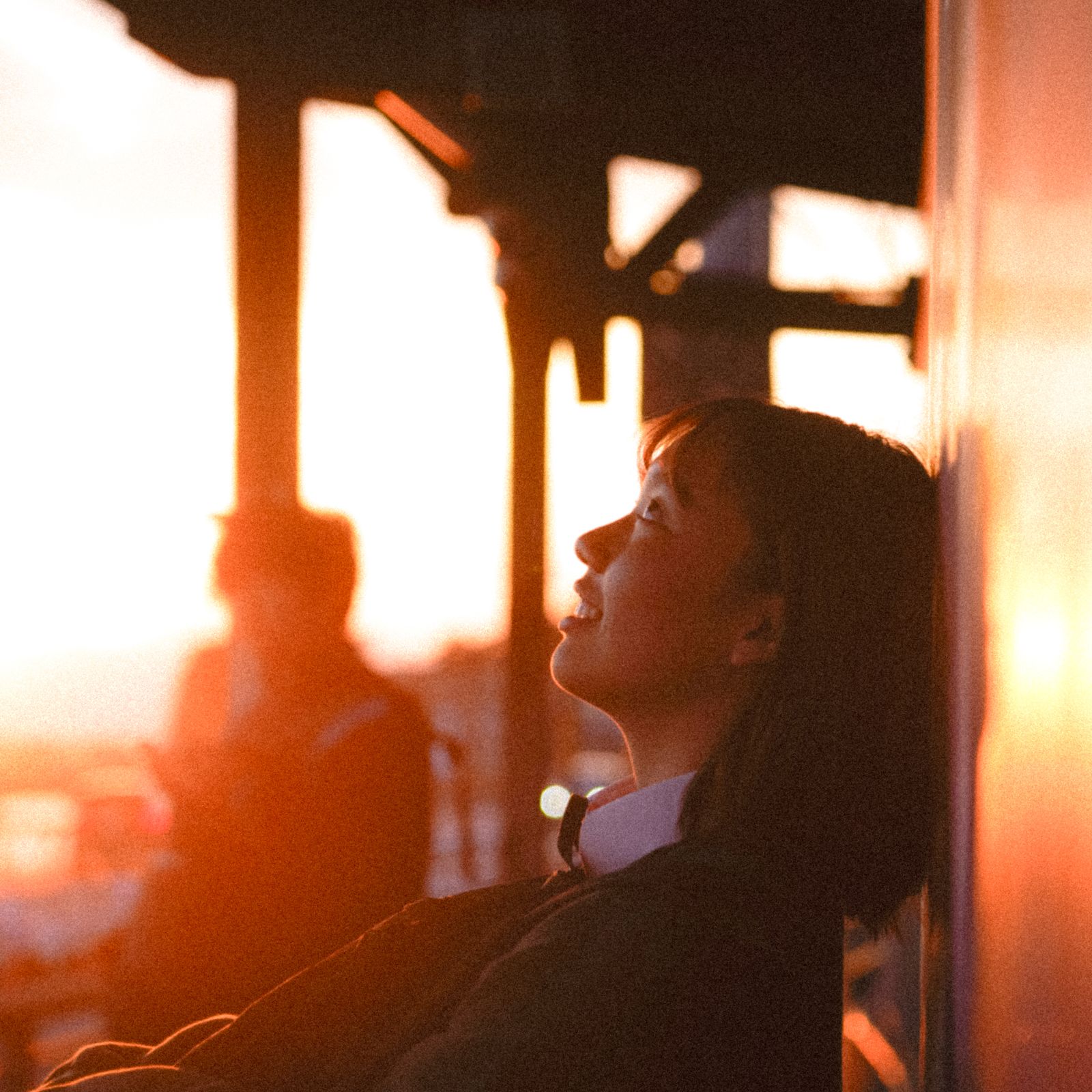 Smiling woman at golden hour learning how to unwind your wired mind