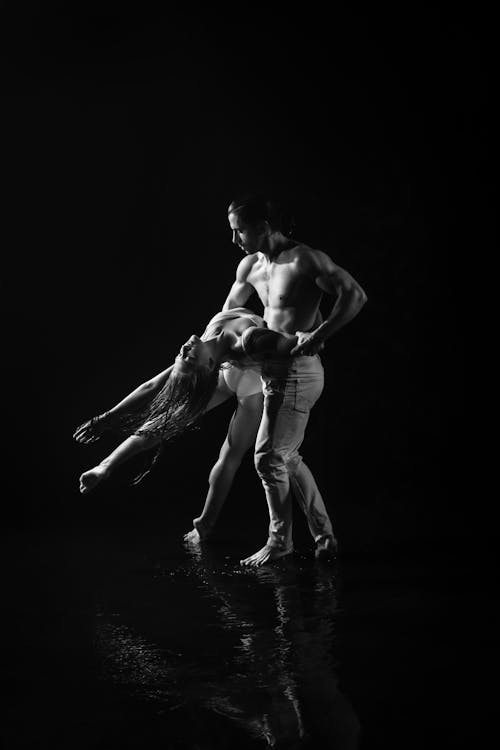 Topless Man Dancing with Woman in Black and White