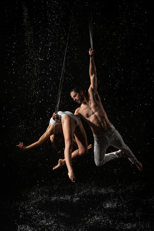 Two People Dancing on a Black Background