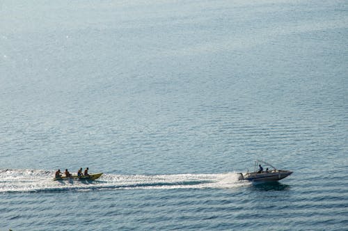 Aerial View of People on Motorboats 