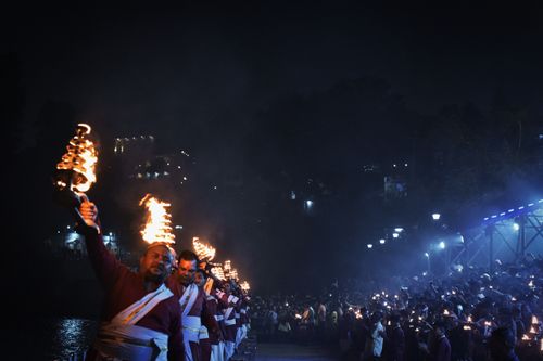 Free Nighttime Ganga Aarti ritual in Rishikesh, India, showcasing spiritual devotion and traditional Hindu practices. Stock Photo