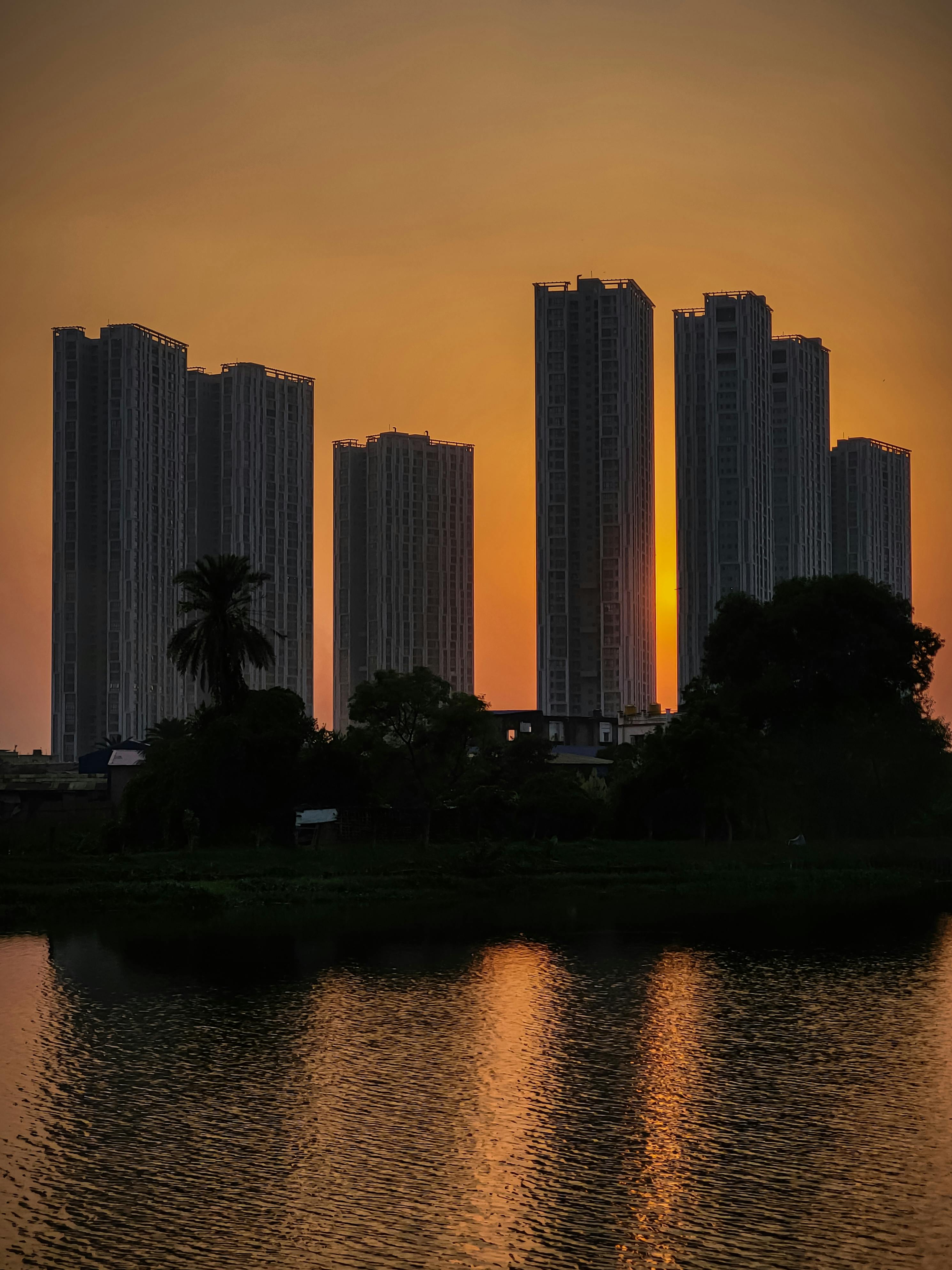 Beautiful view of Kolkata skyline with tall skyscrapers silhouetted against a vibrant sunset.
