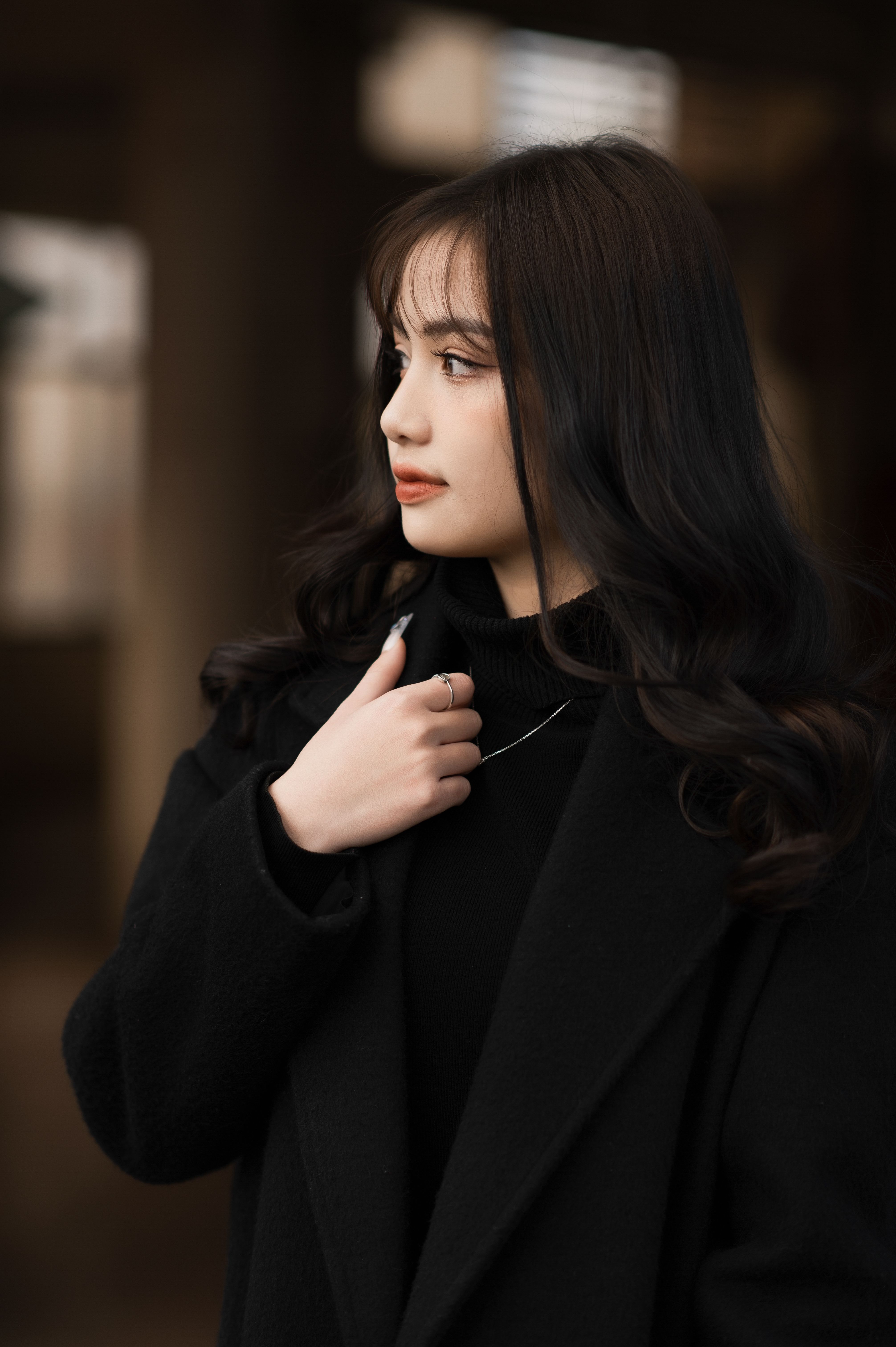 Young woman in a Black Coat Looking Away · Free Stock Photo