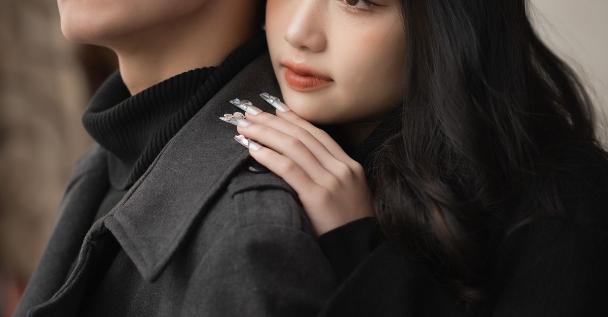 Hugging Coat Young Couple Wearing Coats Standing and Hugging · Free Stock Photo