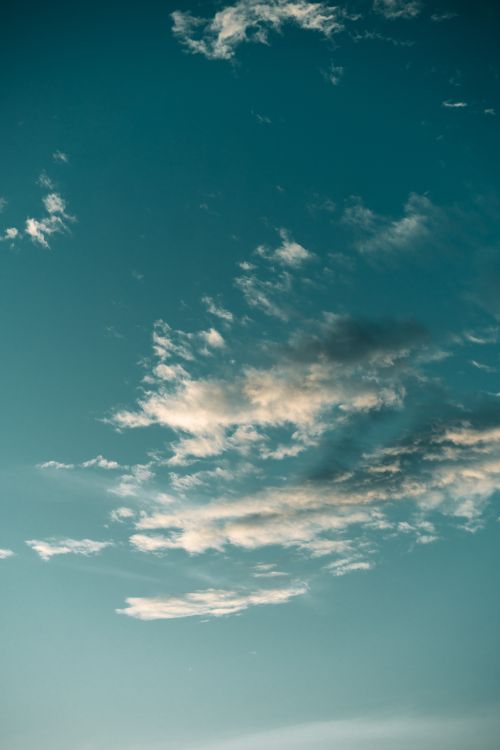 Free A tranquil image of the sky featuring soft clouds and a clear blue atmosphere. Stock Photo
