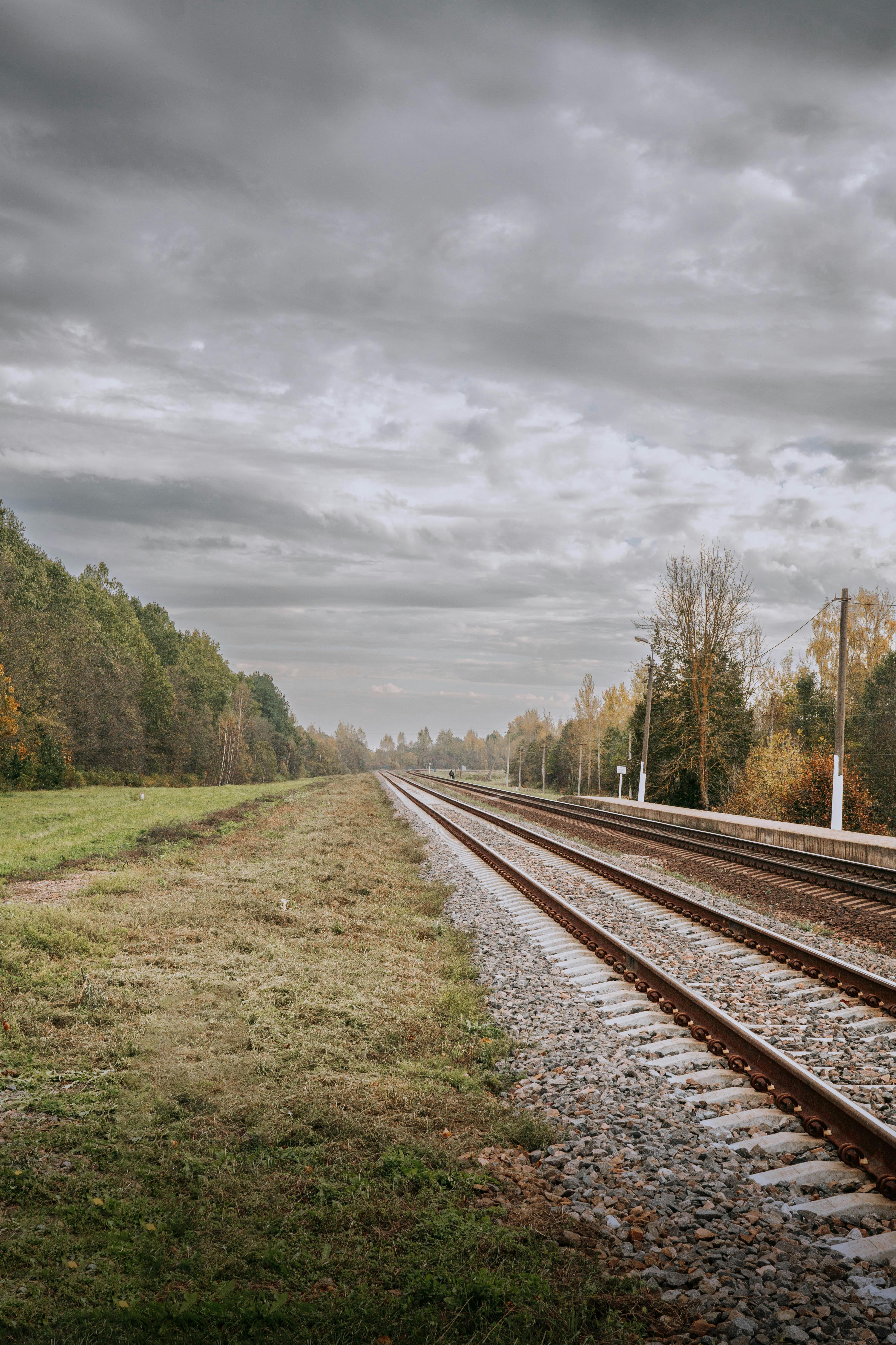 Tranquil railway scene amidst autumn foliage in Bogushevsk, Vitebsk Region, Belarus.