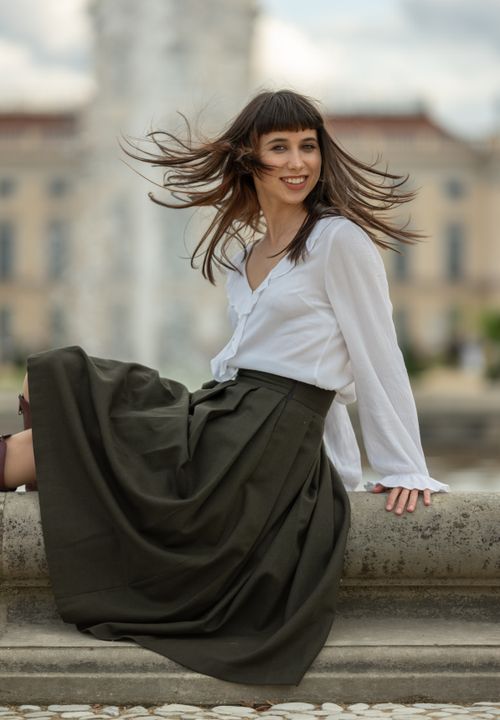 Free A brunette woman elegantly poses in stylish attire outdoors in Berlin. Stock Photo
