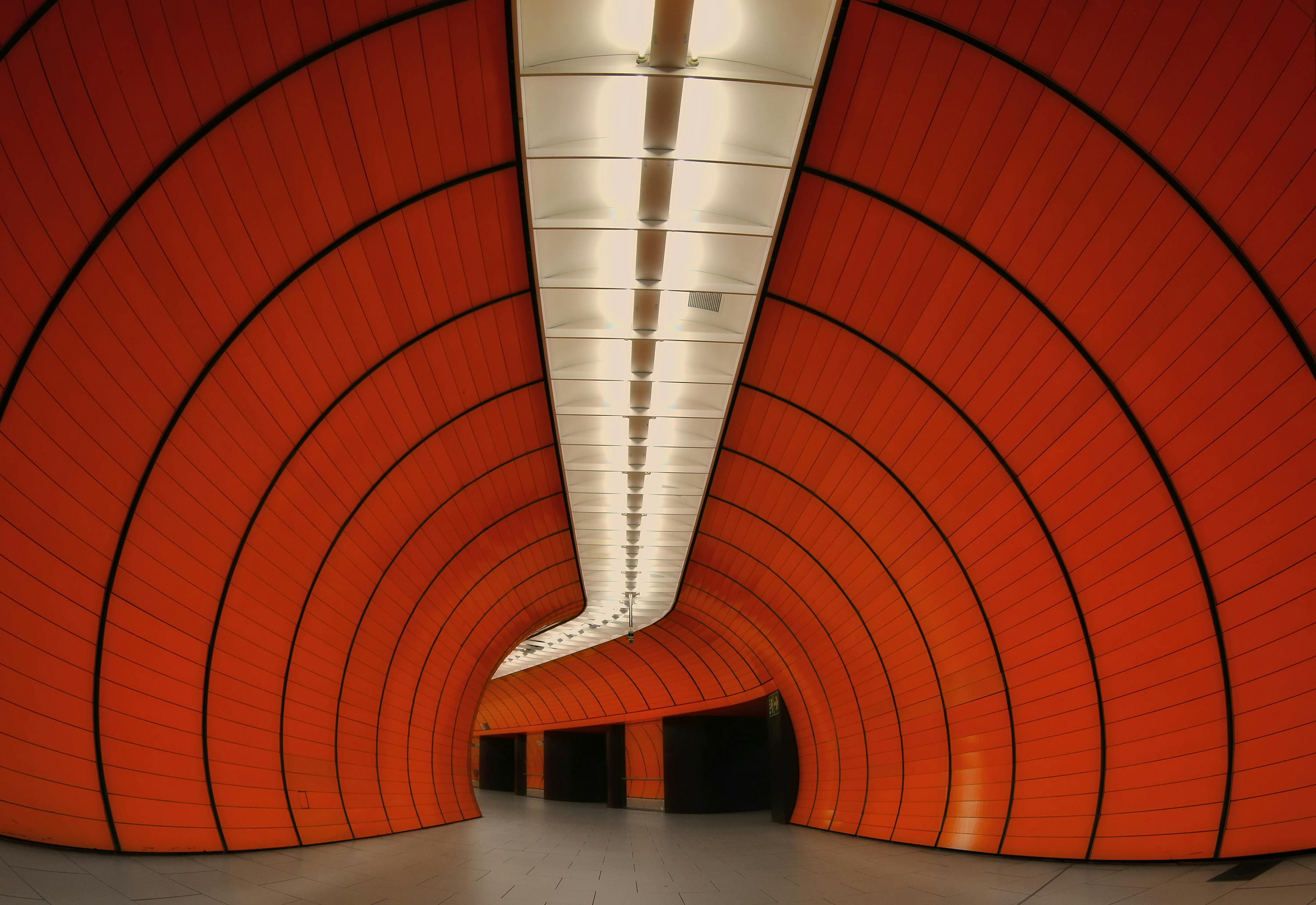Explore the modern design of Munich's Marienplatz subway station with striking orange panels.