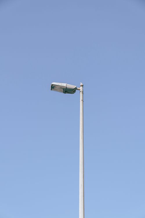 Free Minimalist shot of a street lamp against a clear blue sky in Dubai. Stock Photo