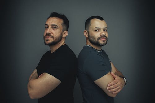 Bearded Men Posing Back to Back in Studio