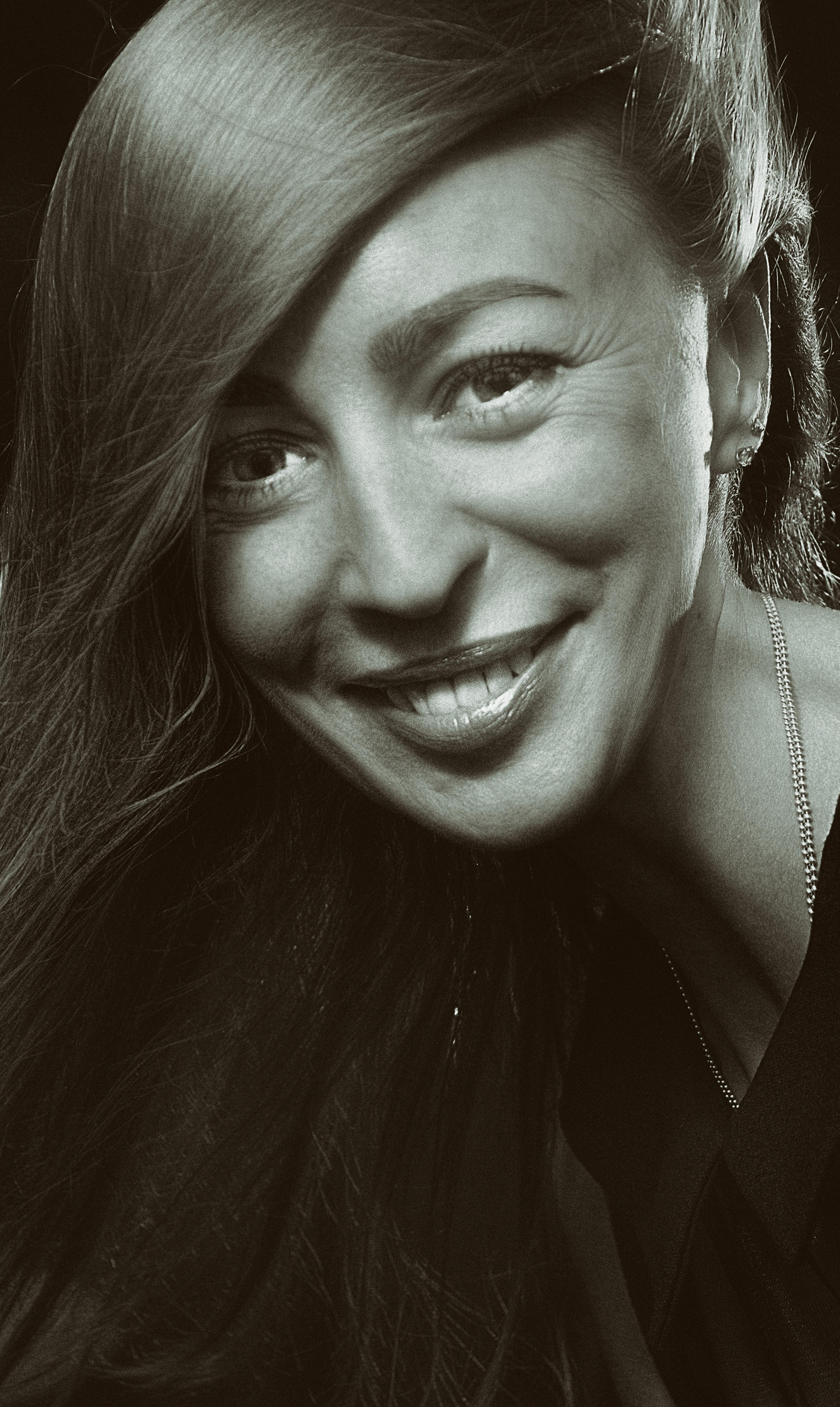 Black and white close-up portrait of a smiling woman