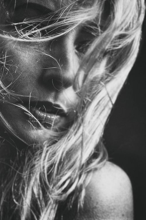 Free Elegantly captured monochrome portrait with hair obscuring face, exuding emotion. Stock Photo