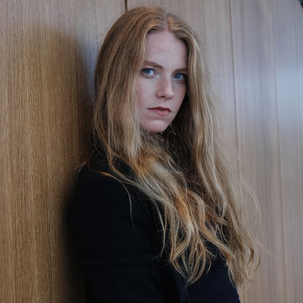 Portrait of a founder against a wooden wall — photo by Denis Kletzel on Pexels