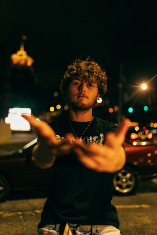 Free Cinematic night portrait of a young adult with curly hair in vibrant downtown Atlanta. Stock Photo
