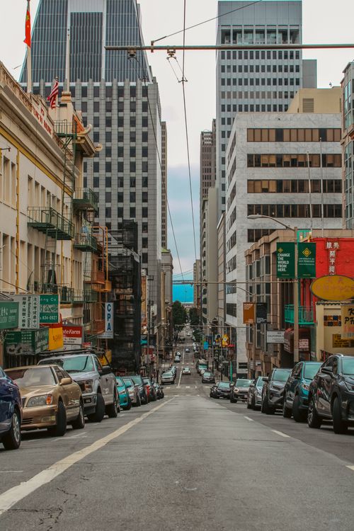 Free Urban cityscape of San Francisco featuring high-rise buildings and bustling street cars. Stock Photo