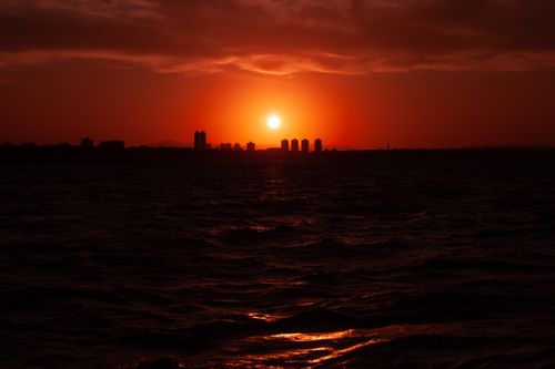 Free Captivating sunset with a red sky over Fortaleza skyline and sea. Stock Photo