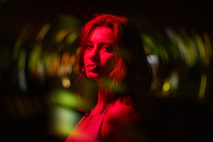Artistic portrait of a woman with dramatic red lighting creating a moody ambiance., by Cihan Karacayir on Pexels
