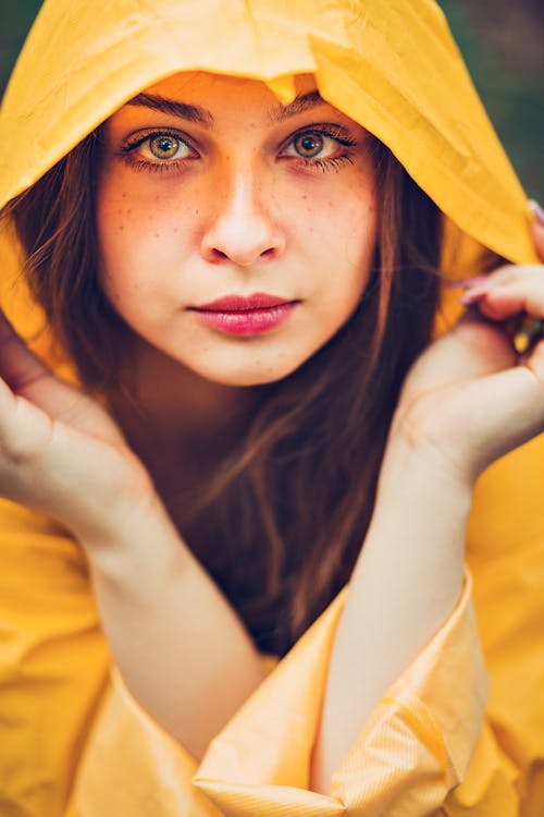 Woman Holding Edge of Hooded Jacket