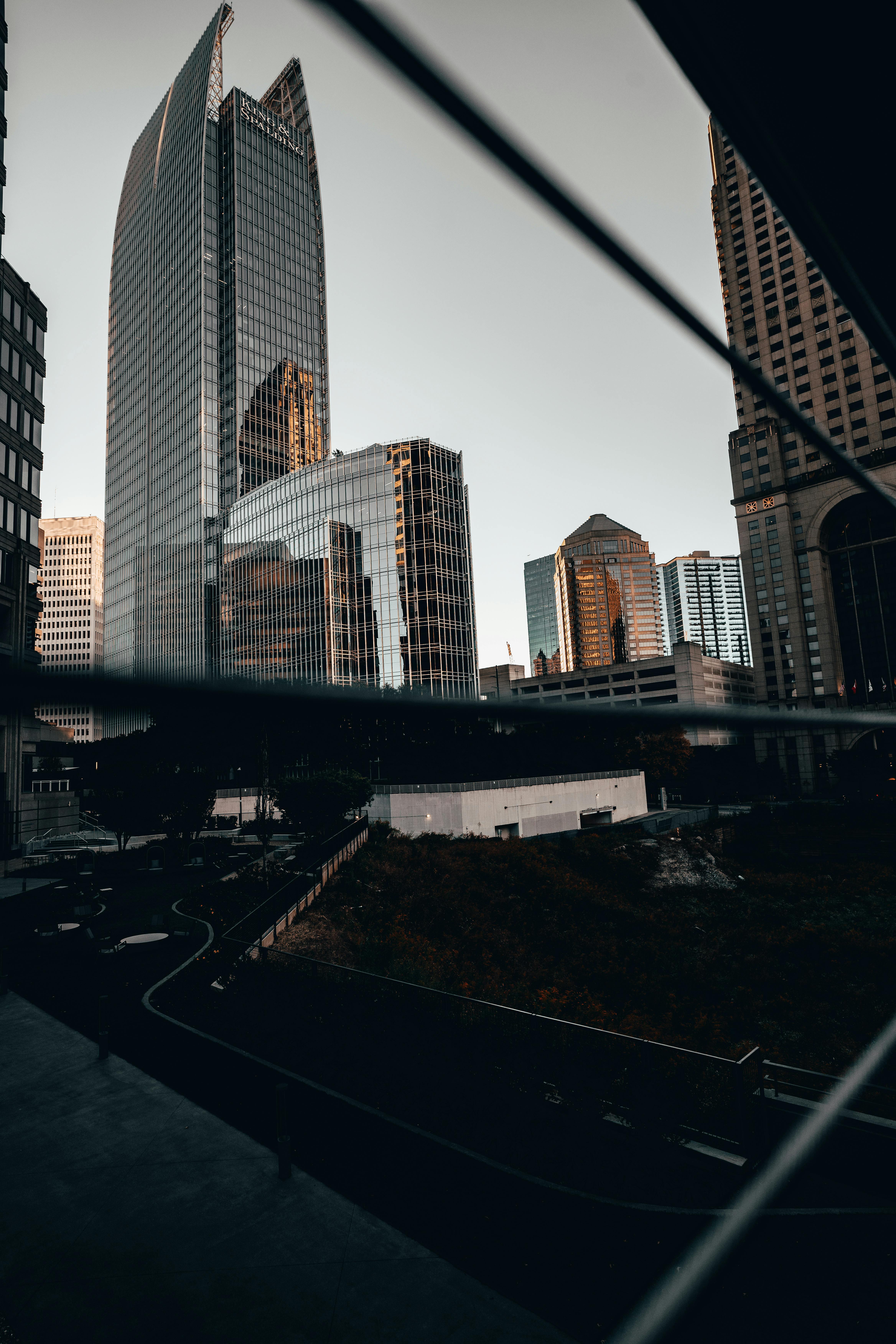 Captivating view of modern skyscrapers reflecting warm sunset hues in an urban cityscape.